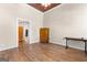 Spacious living room featuring wood floors, vintage wood cabinet, and unique ceiling detail at 2354 Hamilton St, Hampton, GA 30228