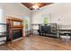 Living room has wood-look flooring, a fireplace with wooden mantle and large window at 2354 Hamilton St, Hampton, GA 30228