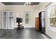 Open-concept room with black vinyl floors, natural light from the windows, and storage cabinets at 2354 Hamilton St, Hampton, GA 30228