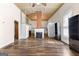 Open living room features a decorative fireplace, wood floors, and tall ceilings at 2354 Hamilton St, Hampton, GA 30228