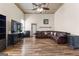 Inviting living room with a large leather sectional sofa, dark furnishings, and wood-look flooring at 2354 Hamilton St, Hampton, GA 30228