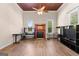 Large, sun-filled living room with wood-look flooring, fireplace and two windows at 2354 Hamilton St, Hampton, GA 30228
