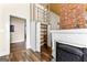 Cozy living room features a brick fireplace and open shelving, blending charm and functionality at 2354 Hamilton St, Hampton, GA 30228