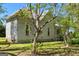 Classic house with a metal roof, showcasing mature trees, and well-maintained landscaping at 2354 Hamilton St, Hampton, GA 30228