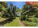 Backyard featuring a manicured lawn, mature trees, and natural landscaping at 395 Hood Ave, Fayetteville, GA 30214