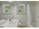 Bright bathroom featuring tile walls, a bathtub with shower, and a window providing natural light at 395 Hood Ave, Fayetteville, GA 30214