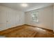 Bedroom featuring neutral paint and carpet, plus two closets and natural light at 395 Hood Ave, Fayetteville, GA 30214