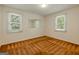 Bedroom featuring neutral paint and carpet, and two windows for natural light at 395 Hood Ave, Fayetteville, GA 30214
