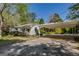 View of the home and a white carport with ample parking space on a concrete driveway at 395 Hood Ave, Fayetteville, GA 30214