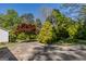 A large driveway surrounded by mature landscaping and trees at 395 Hood Ave, Fayetteville, GA 30214