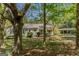 Quaint single-story home with a carport surrounded by mature trees and a leafy yard at 395 Hood Ave, Fayetteville, GA 30214