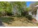 Lush greenery surrounds the side of the house creating a peaceful backyard landscape at 395 Hood Ave, Fayetteville, GA 30214