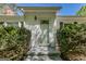 Well-maintained front door with glass detailing and decorative bushes around the entrance at 395 Hood Ave, Fayetteville, GA 30214