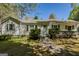 Charming single-story home with white siding, a brick chimney, and front yard landscaping at 395 Hood Ave, Fayetteville, GA 30214
