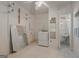 Utility room includes laundry machines, storage shelving, and tile flooring with mirror at 395 Hood Ave, Fayetteville, GA 30214