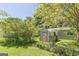 Backyard with metal shed surrounded by landscaping at 1325 E Forrest Ave, East Point, GA 30344