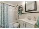 Classic bathroom with a white tiled shower, a black-framed mirror, and a white vanity at 1325 E Forrest Ave, East Point, GA 30344