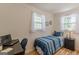 The comfortable bedroom is set up with a workspace and has windows for natural lighting at 1325 E Forrest Ave, East Point, GA 30344