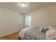 Cozy bedroom featuring hardwood floors, and natural light from window with white curtains at 1325 E Forrest Ave, East Point, GA 30344