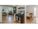 Spacious kitchen with stainless steel stove and view into brick fireplace-equipped living room at 1325 E Forrest Ave, East Point, GA 30344