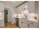 Recently remodeled kitchen with white cabinetry, stainless appliances, and subway tile backsplash at 1325 E Forrest Ave, East Point, GA 30344