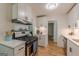 Updated kitchen with stainless appliances, white cabinets, and granite countertops at 1325 E Forrest Ave, East Point, GA 30344