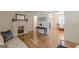 Bright living room featuring a cozy fireplace and hardwood floors extending into adjacent dining area at 1325 E Forrest Ave, East Point, GA 30344