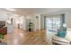 Open-concept living room with hardwood floors, white walls, and a view of the kitchen and porch at 1325 E Forrest Ave, East Point, GA 30344