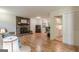 Spacious living room with a brick fireplace, hardwood floors, and an open view to the kitchen at 1325 E Forrest Ave, East Point, GA 30344