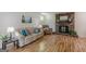 Inviting living room with hardwood floors, a cozy sofa, and a classic brick fireplace at 1325 E Forrest Ave, East Point, GA 30344