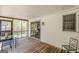 Covered porch with wooden flooring, furniture, and views to screened porch at 1325 E Forrest Ave, East Point, GA 30344