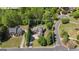 Aerial view of neighborhood featuring manicured lawn, tree-lined street, and well-maintained home at 1105 Astoria Ln, Peachtree City, GA 30269