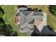Aerial view of a house with a gray roof, wooden deck, driveway, and lush landscaping at 1105 Astoria Ln, Peachtree City, GA 30269