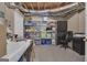 Basement featuring an open ceiling, ample storage shelves, work desk, black office chair and neutral carpeting at 1105 Astoria Ln, Peachtree City, GA 30269