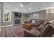 Finished basement with a stone fireplace, leather seating, and a plush rug for a cozy living space at 1105 Astoria Ln, Peachtree City, GA 30269