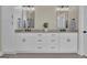 Elegant bathroom featuring double sinks, white cabinets, and modern fixtures at 1105 Astoria Ln, Peachtree City, GA 30269