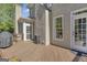 Exterior deck offers a space for outdoor enjoyment, accessible through a screen door and adjacent to a stucco exterior at 1105 Astoria Ln, Peachtree City, GA 30269