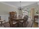 Inviting dining room featuring a wooden table, vintage rug, and natural light at 1105 Astoria Ln, Peachtree City, GA 30269
