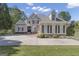 Stunning two-story stucco home with manicured lawn and a large circular driveway, showing impeccable curb appeal at 1105 Astoria Ln, Peachtree City, GA 30269