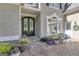 Elegant entryway with a double door, stone patio, and beautifully arranged flower pots for a welcoming appeal at 1105 Astoria Ln, Peachtree City, GA 30269