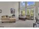 Sun-lit living area featuring neutral tones, plush seating, and soaring windows for an inviting atmosphere at 1105 Astoria Ln, Peachtree City, GA 30269