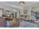 Open-concept living room with hardwood floors flows seamlessly into the kitchen, creating a spacious and inviting area at 1105 Astoria Ln, Peachtree City, GA 30269
