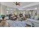 Spacious living room with comfortable seating, hardwood floors, and natural light from large windows offers an inviting atmosphere at 1105 Astoria Ln, Peachtree City, GA 30269