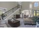 Open-concept living area showcasing a staircase, view to dining room, and neutral color scheme at 1105 Astoria Ln, Peachtree City, GA 30269