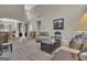 Spacious living room with a fireplace, comfortable sofa, and staircase leading to the upper level of the home at 1105 Astoria Ln, Peachtree City, GA 30269
