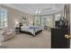 Inviting main bedroom with tray ceiling, cozy seating area, and large windows offering ample natural light at 1105 Astoria Ln, Peachtree City, GA 30269