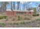 Welcoming Kedron Hills brick neighborhood sign is framed by lush greenery and landscaping at 1105 Astoria Ln, Peachtree City, GA 30269