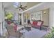 Inviting covered patio with wicker furniture, ceiling fan, and exterior door provides a comfortable outdoor living space at 1105 Astoria Ln, Peachtree City, GA 30269