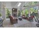 Inviting covered patio with stone fireplace, ceiling fan, skylight, and wicker furniture offers a relaxing outdoor living space at 1105 Astoria Ln, Peachtree City, GA 30269