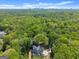 Stunning aerial view of home among verdant trees, showcasing lush landscaping and proximity to the city at 3985 Randall Mill Nw Rd, Atlanta, GA 30327